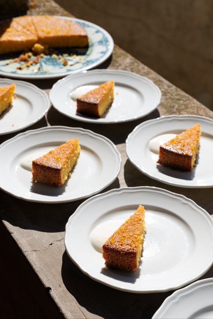 Slices of cake on a number of white china plates