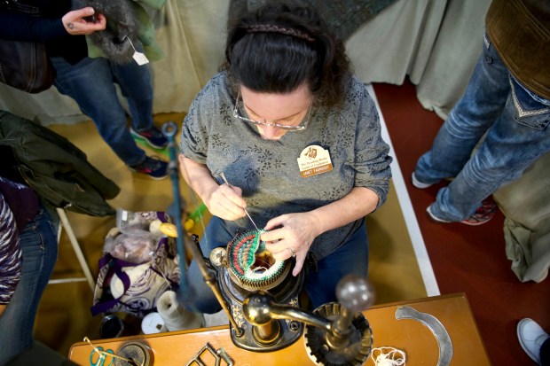 Janet Fasnacht, a master fiber artist, works on a piece during the Reading-Berks Guild of Craftsmen's 73rd annualHoliday Fine Art & Craft Festival at Kutztown University on Saturday. (SPECIAL TO THE READING EAGLE:SUSAN L. ANGSTADT)