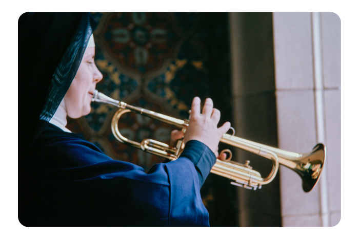 A nun playing a trumpet