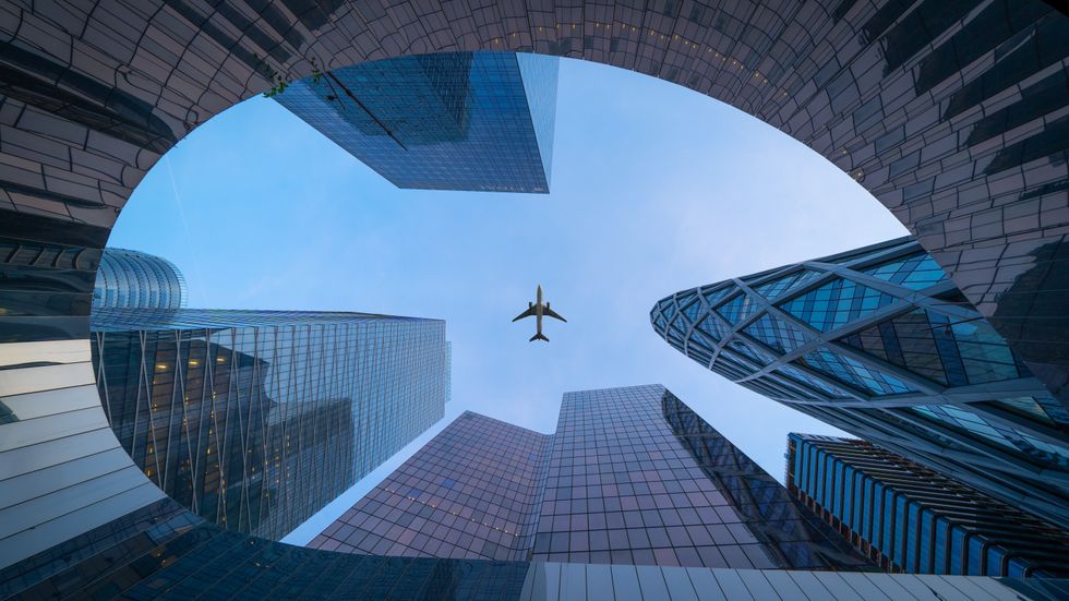 Photograph of an \u200bAirplane flying over La D\u00e9fense