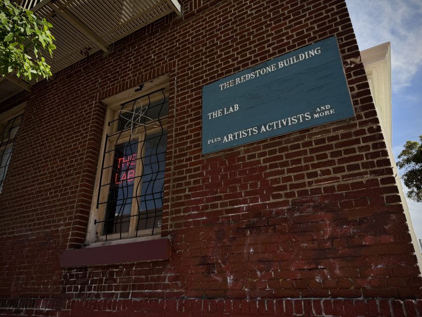 A brick building with a sign on it.