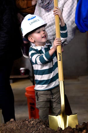 Wells Beckham, 4, takes hold of a ceremonial shovel during one several groundbreaking photo opportunities as a large group celebrated the commencement of construction at Abilene Heritage Square Thursday.