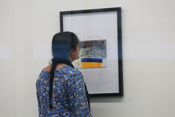 A person looks at a painting