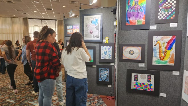 Attendees of the 9th annual Window on a Wider World Youth Art Show check out some of the student artwork in November 2022 at the Amarillo Civic Center.