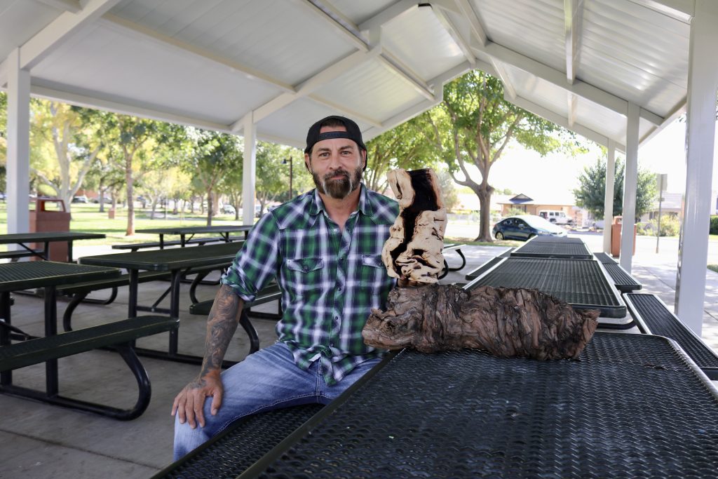 Dustin McLaughlin, the owner of The Humblewood Company, holds one of his wood lamps, St. George, Utah, Oct. 11, 2023 | Photo by Jessi Bang, St. George News