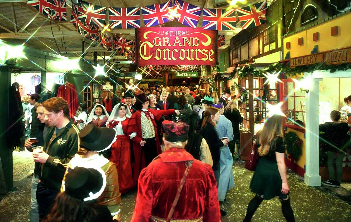 Yuletide revelers celebrate the season as they explore the vibrant Grand Concourse of the Great Dickens Christmas Fair and Victorian Holiday Party at the Cow Palace.