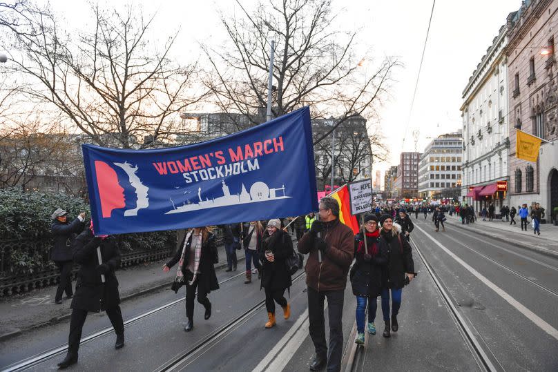 Protesters carrying banners and placards take part in a Women's March in Stockholm, Sweden, Saturday, Jan. 21, 2017