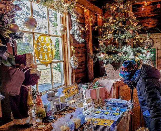 Shoppers check out placemats and home décor items from a vendor at the 2022 Door County Christkindlmarkt in Sister Bay. Thirty-seven vendors are participating in this year's third annual market, taking place three straight weekends in November and December.