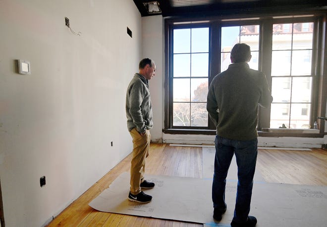 The father and son team of Tony, left, and Hank Brown inspect the status of apartment renovations at the Updegraff building on West Washington Street in Hagerstown.