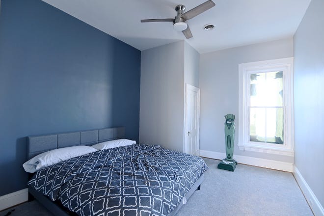 A king-size bed fits in the bedroom at a renovated apartment on South Potomac Street.