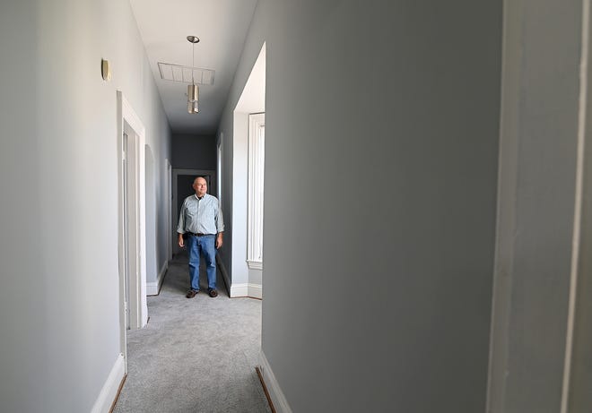 Developer Lloyd Thoburn shows visitors through the renovated apartment at 357 S. Potomac St. in Hagerstown.