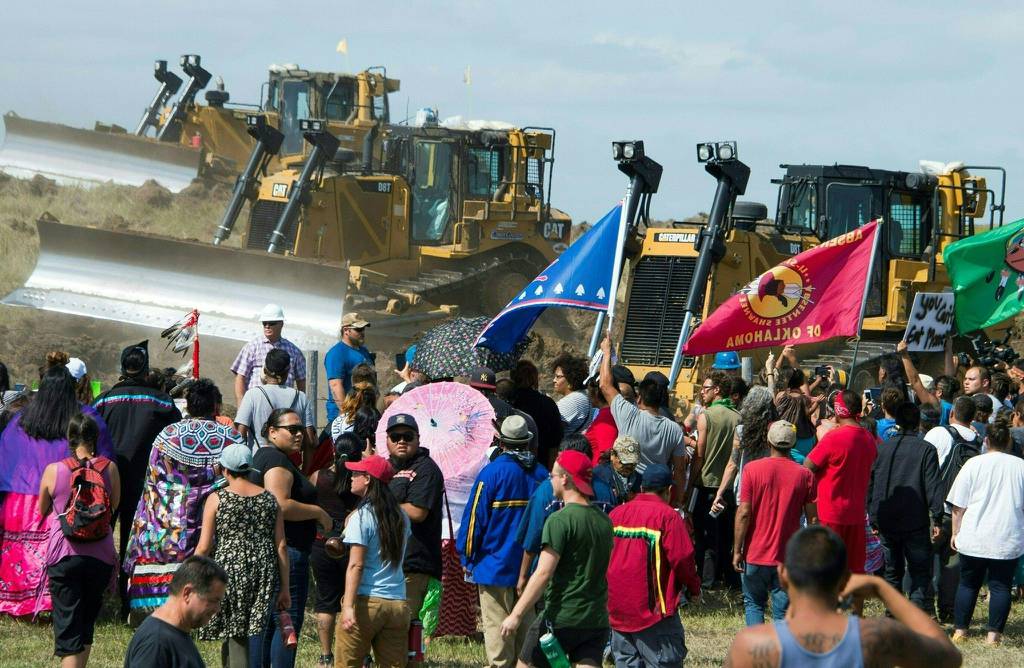 Members of the Standing Rock Sioux Tribe and their supporters confront bulldozers working in 2016 on the Dakota Access Pipeline near Cannon Ball, North Dakota.
