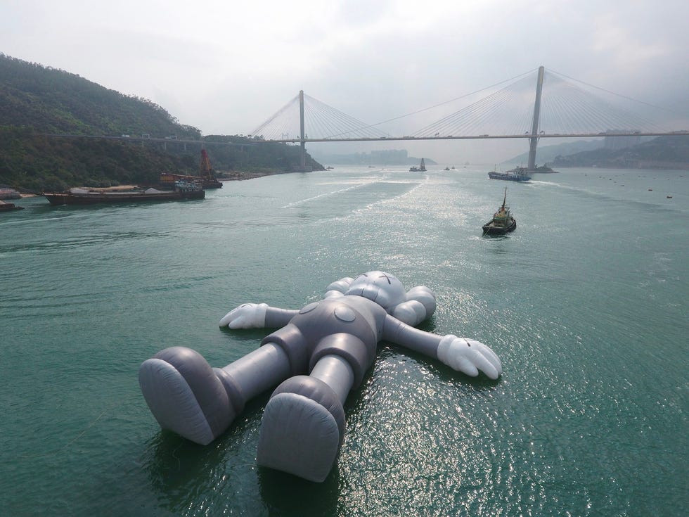 KAWS' sculpture 'Companion' floats in Victoria Harbor in Hong Kong on March 22, 2019.