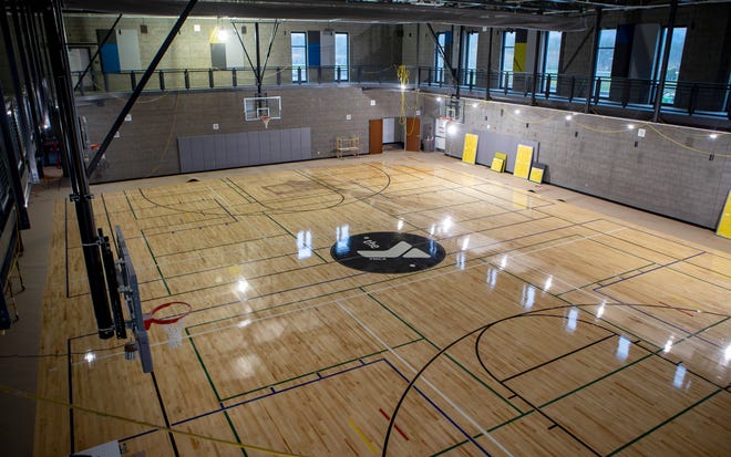 Floor markings for volleyball, basketball and pickle ball line the gym floor.