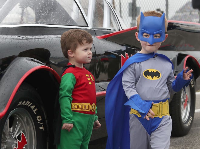 Caped crusaders Walker Flury, 2, and Wyatt Flury, 4, hang out with the Batmobile at the 50th annual fall Turkey Run at Daytona International Speedway. The event runs through Sunday in Daytona Beach.
