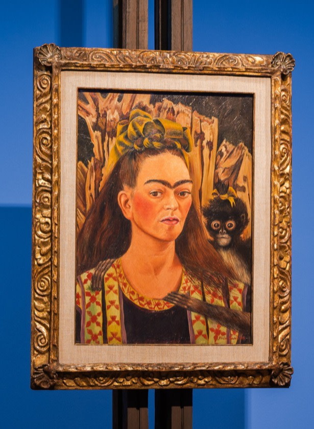 Oil painting of a woman with extremely prominent brows and a monkey on her shoulder