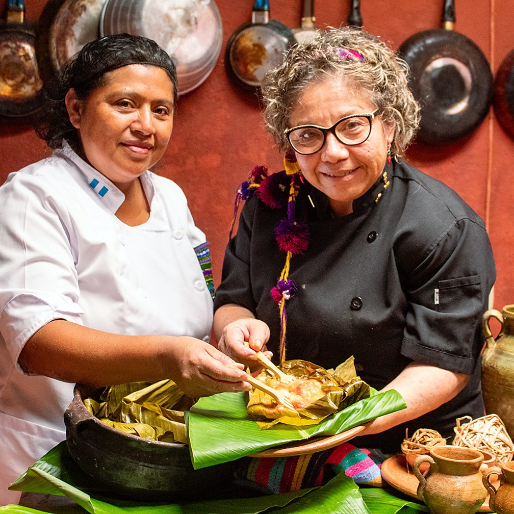 Hugo Espinoza Archaeogastronomist Regina Moraga and Silvia Arias share a finished tamale (Credit: Hugo Espinoza)