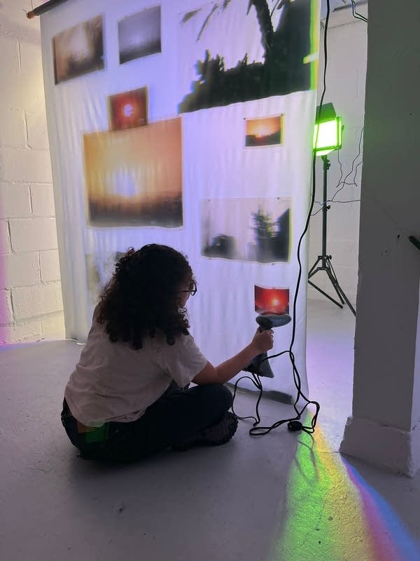 An artist works on a photo installation.