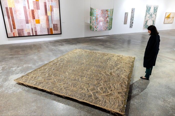 A person observes the piece Aleaciones con Memoria de Forma II from the artist Ximena Garrido, at the exhibition ‘To Weave the Sky: Textile Abstractions from the Jorge M. Perez Collection’ at El Espacio 23 gallery in Miami, Florida, US