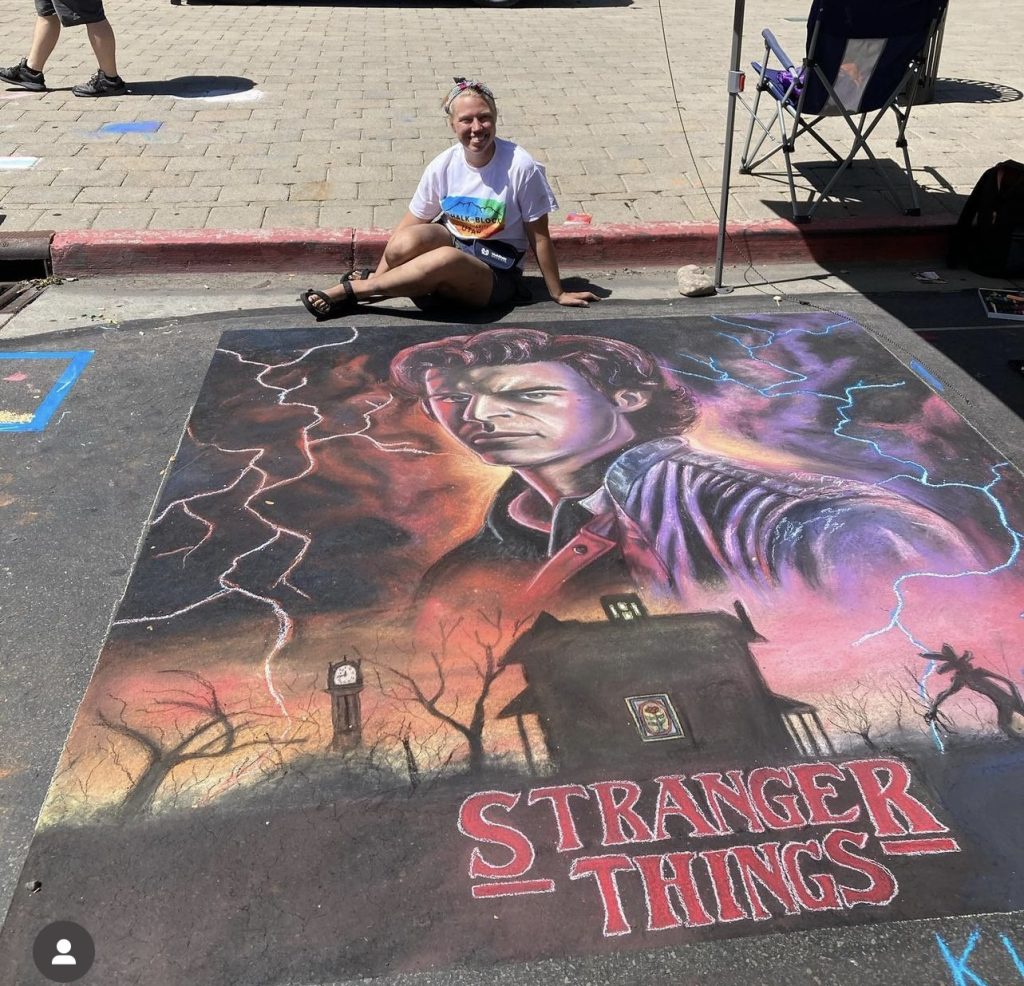 Kimberly Ipson sits next to her Stranger Things chalk art during a chalk art festival in Provo, Utah, date unspecified | Photo courtesy of Kimberly Ipson, St. George News