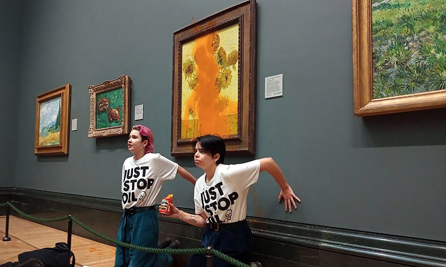 Activists from Just Stop Oil climate campaign group threw tomato soup on Vincent van Gogh's "Sunflowers" and glued their hands to the wall beneath the painting at the National Gallery in London on Oct. 14. They were arrested and charged with criminal damage and aggravated trespass.