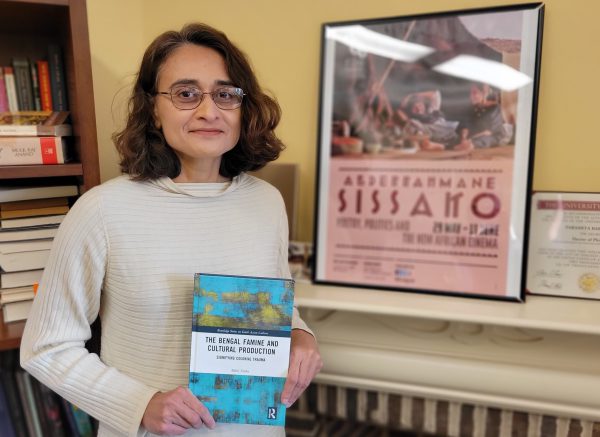 Professor of English Babli Sinha holding her book on the Bengal famine