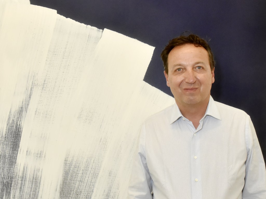 PARIS, FRANCE - JUNE 12: Gallerist Emmanuel Perrotin poses with A work of Hans Hartung during 