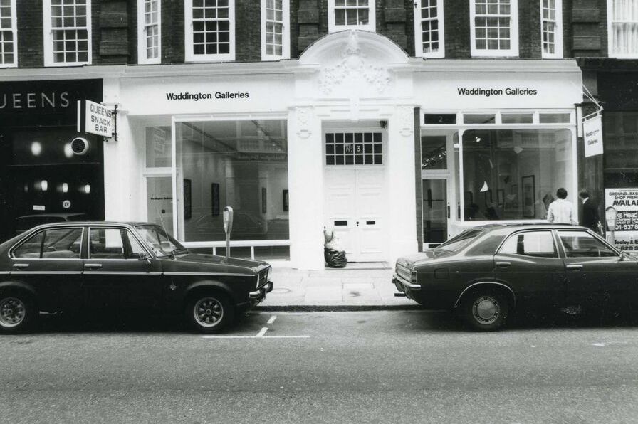 a couple of cars parked outside a building