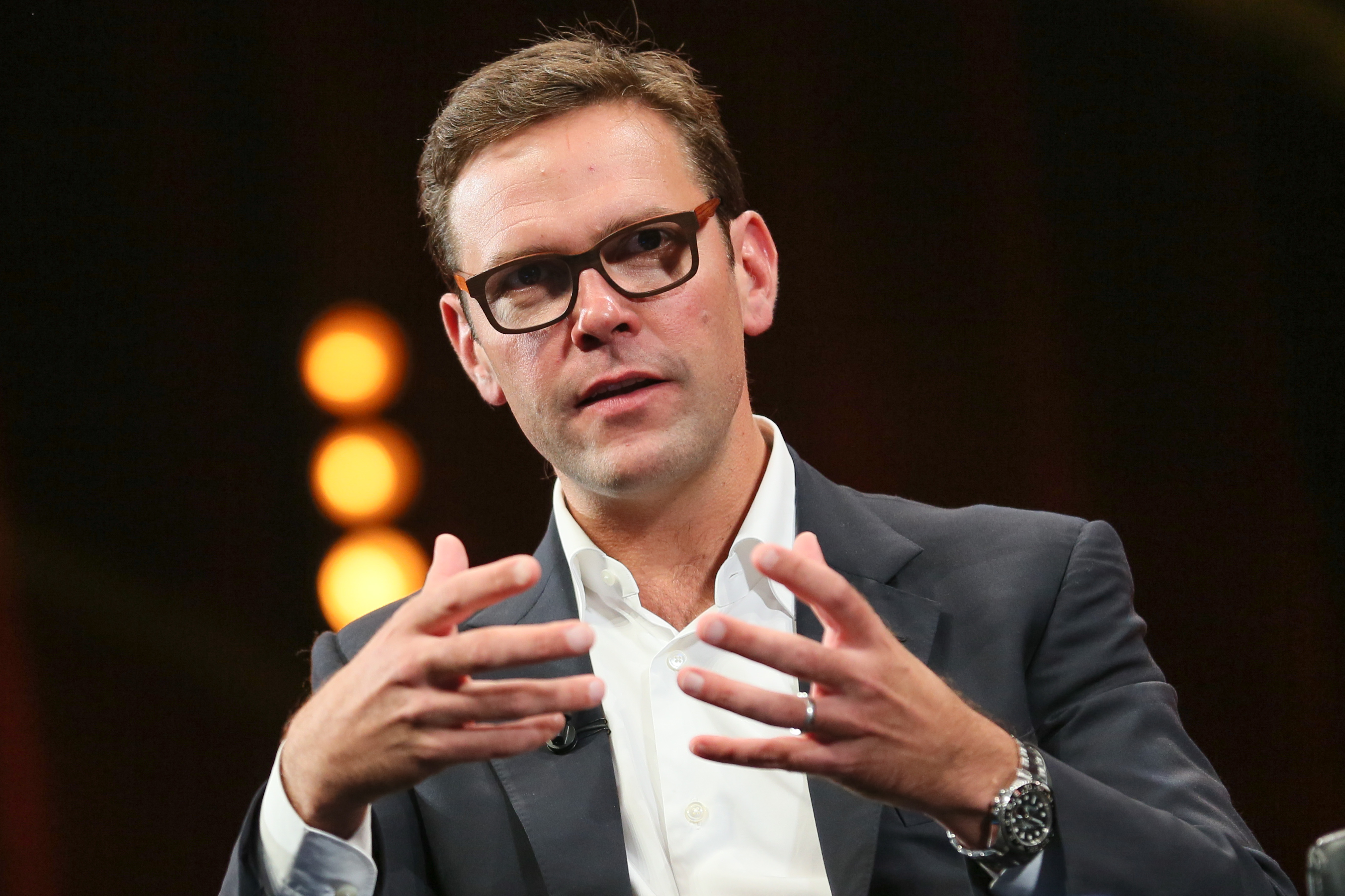 Middle-aged man wearing glasses and suit.