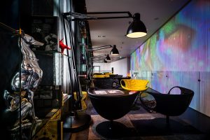 dark interior with statement black lamps and round black chairs in the library of artotel Amsterdam