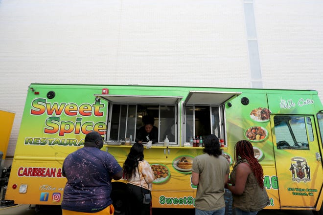 Customers visit the Sweet Spice food truck during the 2nd annual Savannah Black Art Expo on Saturday, February 3, 2024 at the Savannah Cultural Arts Center.