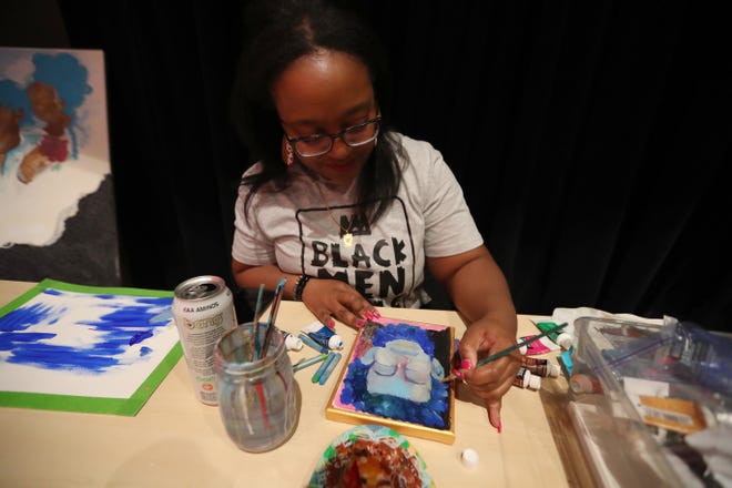 Artist Nae'Keisha Jones works on a piece at her booth during the 2nd annual Savannah Black Art Expo on Saturday, February 3, 2024 at the Savannah Cultural Arts Center.