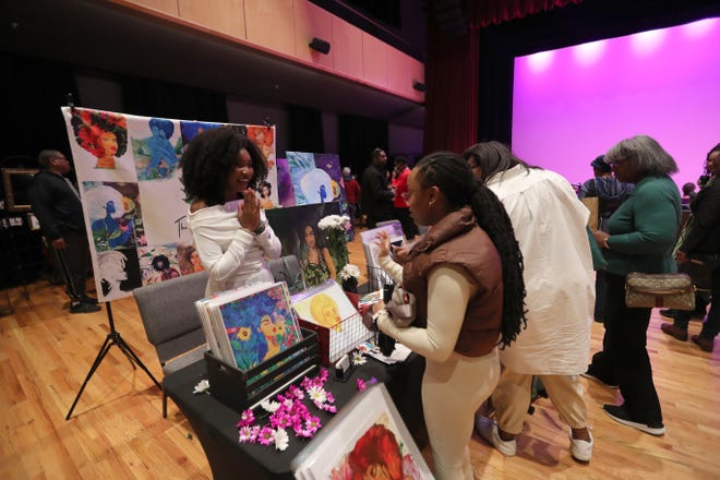 Artist Jae Daisy talks with a customer during the 2nd annual Savannah Black Art Expo on Saturday, February 3, 2024 at the Savannah Cultural Arts Center.