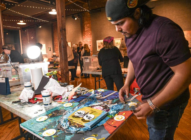 Orlando Corona makes a mixed-media art piece during the 2024 Art Slam! at Anderson Arts Center Friday, February 9, 2024. The third annual event sponsored by Ryobi and presented by the art center and Anderson County Library, raised money for the art center.