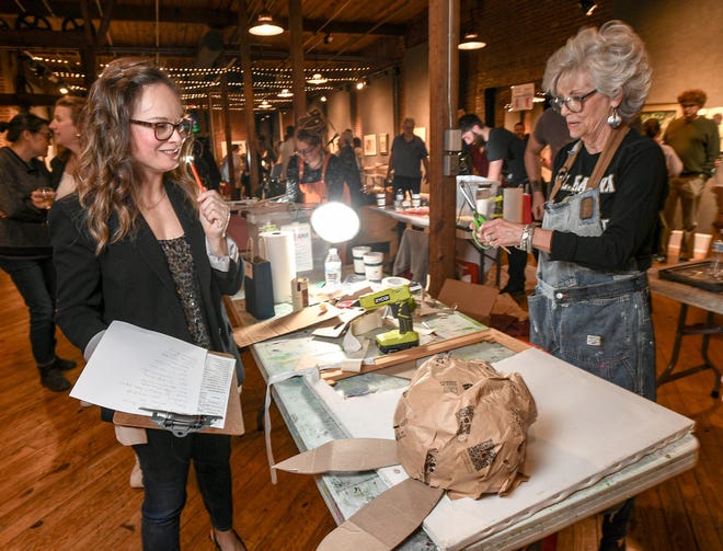 Judge Annie Sutton, left, Director of the Anderson County Library, watches as Kathy Moore, right, makes mixed-media art during the 2024 Art Slam! at Anderson Arts Center Friday, February 9, 2024.