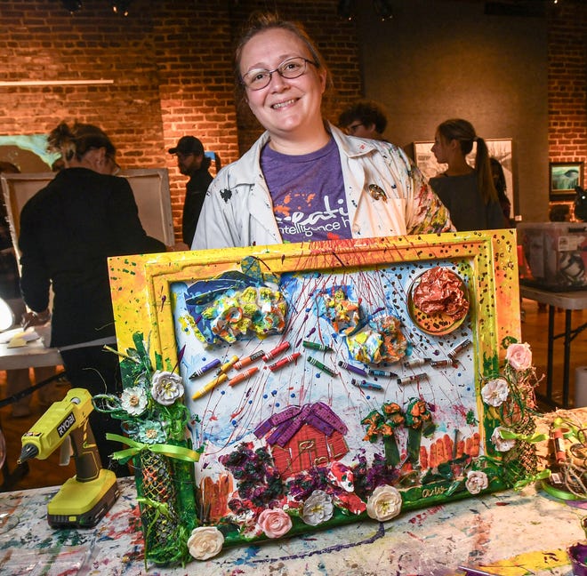 Andrea Williams near her finished mixed-media art during the 2024 Art Slam! competition at Anderson Arts Center Friday, February 9, 2024.