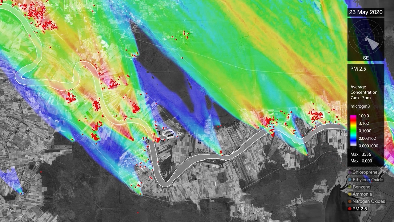 Aerial view of landscape covered by rainbow-hued airborne pollutants