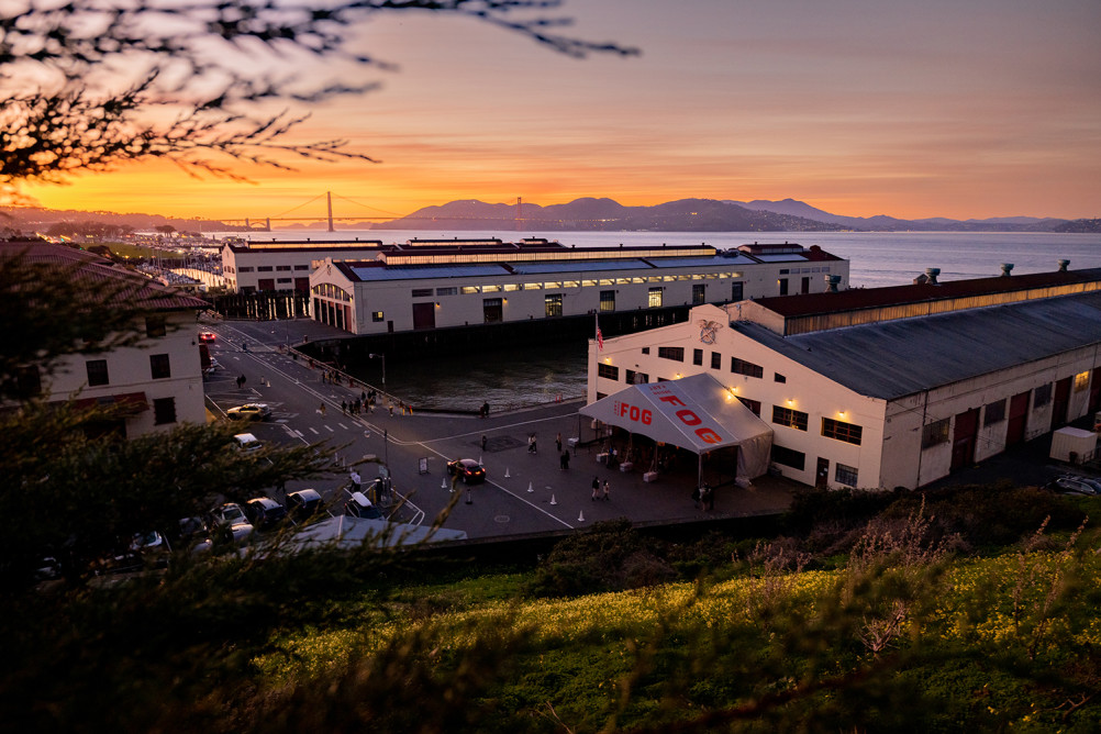 Overhead view of pier buildings with sunset and bay in background