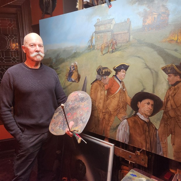 Artist standing next to large canvas with painting in progress