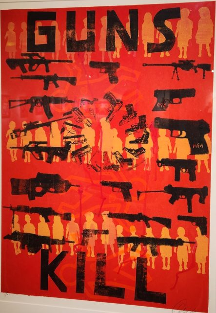 A poster with the words guns kill on it.
