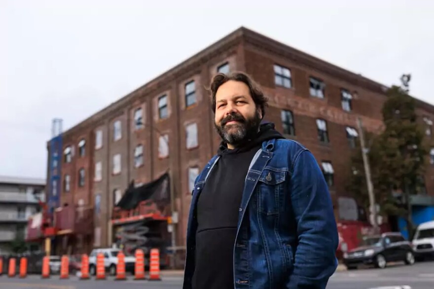 Quebecois filmmaker Maxime-Claude L'Ecuyer stands in front of the building known as 305 Bellechasse. For decades in Montreal, it housed dozens of reknowned local painters and artists who kept their studios there. Recently, the building was sold and renovated and the artists evicted. L'Ecuyer's film, "305 Bellechasse," captures the artists' studios and voices before the upheaval.