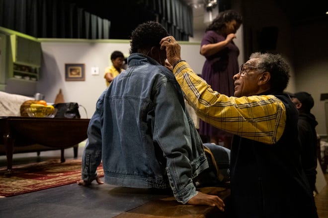Clark Nesbit adjusts Gavin Rector's microphone, who plays Travis Younger in A Raisin in the Sun, directed by Nesbit, during a dress rehearsal at Simpsonville Arts Center on Wednesday, Jan. 24, 2024.