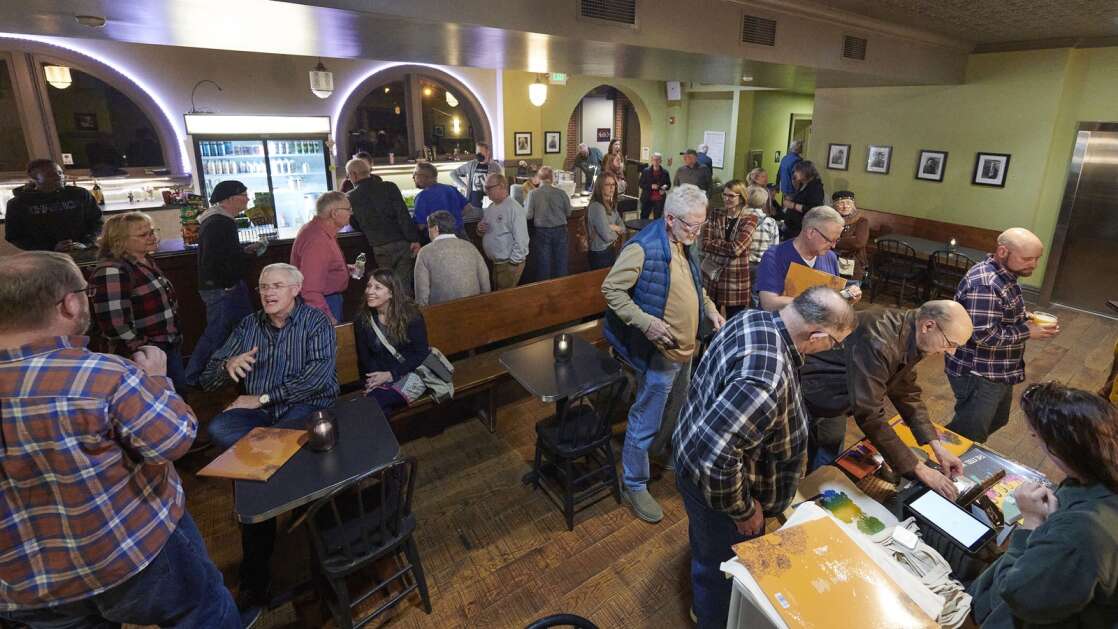 The lobby fills as attendees mingle, order drinks at the bar and purchase merchandise during an intermission in the Feb. 24 performance by Americana band “The Steel Wheels” at CSPS Hall in Cedar Rapids. (Cliff Jette/Freelance for The Gazette)