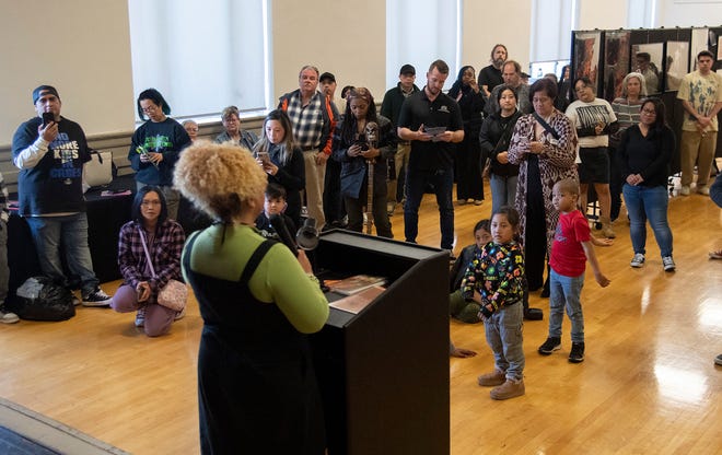 Stockton Poet Laureate Jazmarie LaTour, left, gives a spoken word performance at the Stockton Arts Commission's inaugural Arts Night at the Stockton Memorial Civic Auditorium in downtown Stockton on Mar. 12, 2024. More arts nights are scheduled quarterly from 4:00 to 7:00 p.m on Jun. 5, Sept. 11 and Dec. 11. Artists and performers can apply for upcoming arts nights on the Stockton Arts Commission's page on the City of Stockton's website https://tinyurl.com/ynmxvaxh .