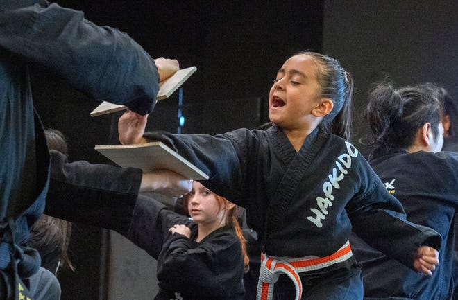 Student Leah Nguyen breaks a board with her open hand while performing a routine with the Apex Martial Arts Academy perform a routine at the Stockton Arts Commission's inaugural Arts Night at the Stockton Memorial Civic Auditorium in downtown Stockton on Mar. 12, 2024. More arts nights are scheduled quarterly from 4:00 to 7:00 p.m on Jun. 5, Sept. 11 and Dec. 11. Artists and performers can apply for upcoming arts nights on the Stockton Arts Commission's page on the City of Stockton's website https://tinyurl.com/ynmxvaxh .