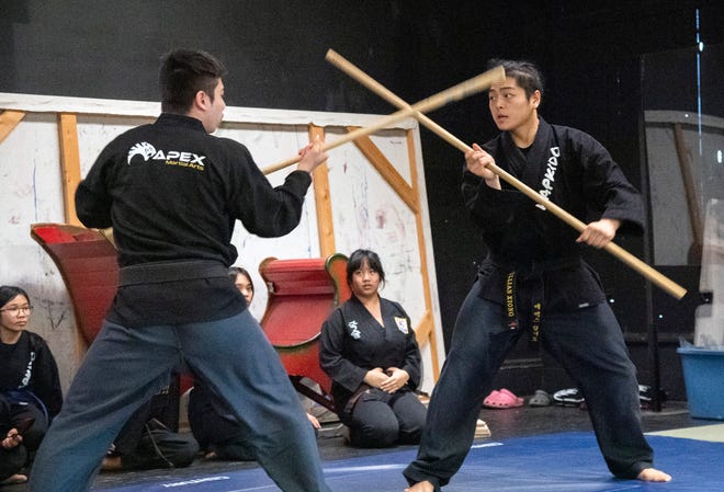 Students Kogan Perez, left, and Jullian Xiong spar with staffs while performing a routine with the Apex Martial Arts Academy perform a routine at the Stockton Arts Commission's inaugural Arts Night at the Stockton Memorial Civic Auditorium in downtown Stockton on Mar. 12, 2024. More arts nights are scheduled quarterly from 4:00 to 7:00 p.m on Jun. 5, Sept. 11 and Dec. 11. Artists and performers can apply for upcoming arts nights on the Stockton Arts Commission's page on the City of Stockton's website https://tinyurl.com/ynmxvaxh .