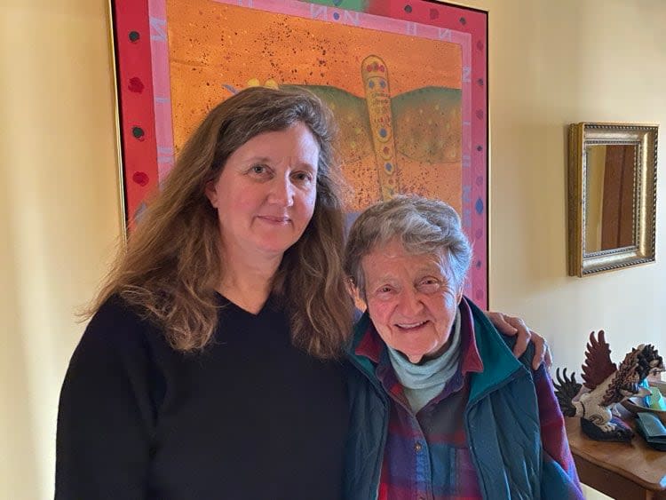 Susana Rutherford, left, and Gail Ambika Rutherford, in front of a painting by Erica Rutherford. 