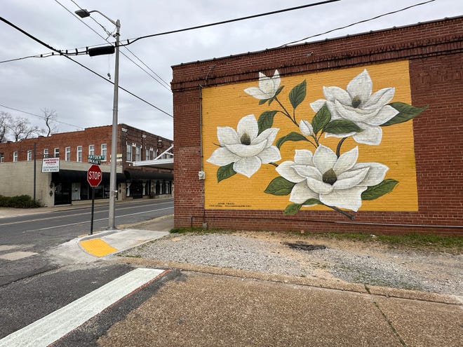 The magnolias wall was painted by Lindsay Moore and Chastity Sayer Smith of Paint It Up Murals for Louisiana Fireplace located on Main Street in Pineville.