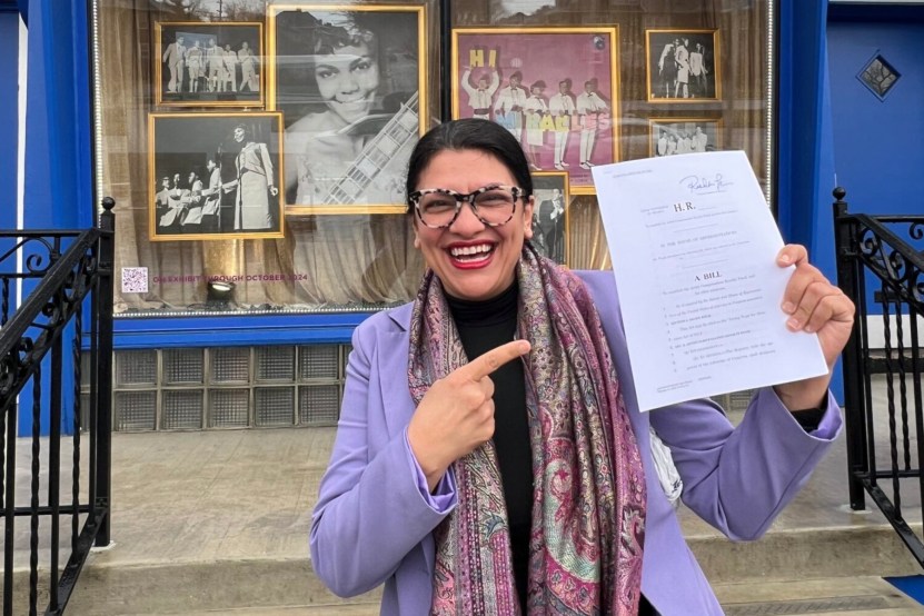 Rashida Tlaib holding a copy of the Living Wage for Musicians Act outside the headquarters of Motown in Detroit.