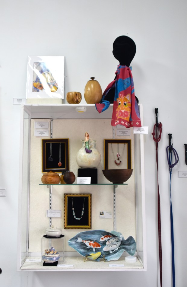 Turned vessels by Larry Fisher, silk scarf by Carolyn Seabolt, painted porcelain by Teri Koenig, lamp glass bead work by Amy Selmer, watercolor by Tatiana Bell, iron dog leash holders by Jacob Selmer. (Lyndi McNulty photo)